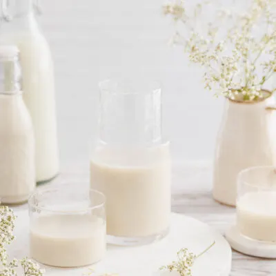 Karaffe und Glas mit Hafermilch.