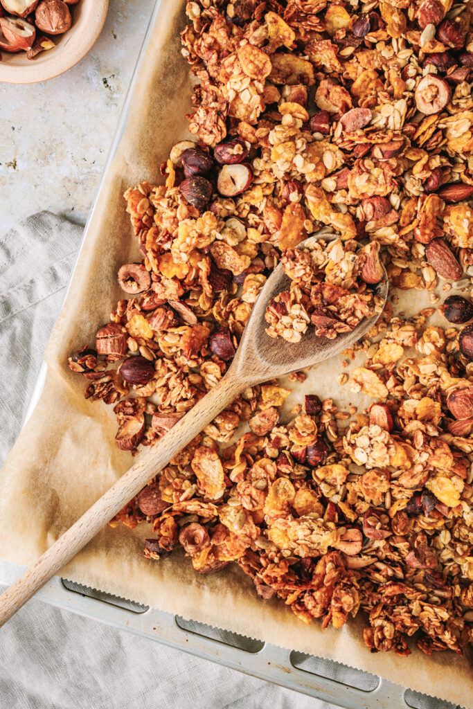 Knuspriges Granola mit Nüssen auf dem Blech.